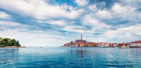 Spectacular spring cityscape of Rovinj town, Croatian fishing port on the west coast of the Istrian peninsula. Colorful morning seascape of Adriatic Sea. Traveling concept background.Spectacular