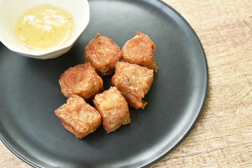 deep fried crab roll dumpling dipping sweet sauce on dish