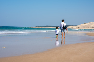 Father and son taking a stroll along the coastline