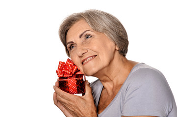 Portrait of smiling senior woman posing with present