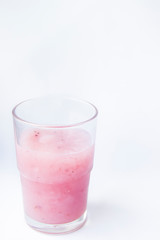 Drinking yogurt in a glass on a white background. Beautiful delicious pink fruit yogurt. Natural detoxification. Healthy eating concept. Fresh homemade yogurt for Breakfast. Fruit yogurt smoothie.