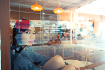 woman Look out of window city reflect