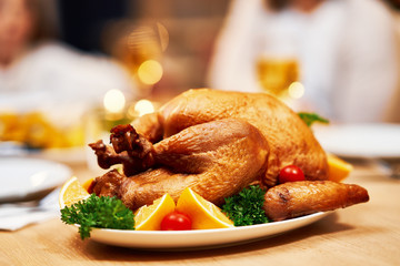 Family celebrating Thanksgiving. Focus on table and dishes