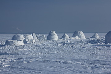 Winter landscape with ice igloo on white snow background.