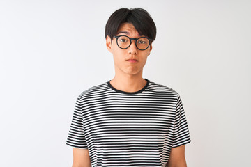 Chinese man wearing glasses and navy striped t-shirt standing over isolated white background depressed and worry for distress, crying angry and afraid. Sad expression.