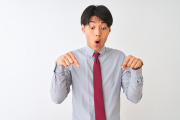 Chinese businessman wearing elegant tie standing over isolated white background Pointing down with...