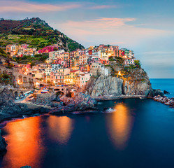 Fototapeta na wymiar Second city of the Cique Terre sequence of hill cities - Manarola. Impressive spring sunset in Liguria, Italy, Europe. Picturesqie seascape of Mediterranean sea. Traveling concept background.