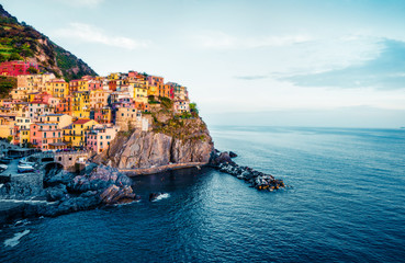 Second city of the Cique Terre sequence of hill cities - Manarola. Colorful spring morning in Liguria, Italy, Europe. Picturesqie seascape of Mediterranean sea. Instagram filter toned.
