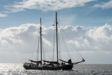 Sailboat departs from the port of Nes in Ameland and goes to the Wadden Sea