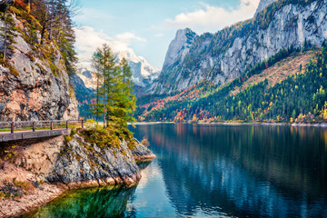 Attractive autumn scene of Vorderer ( Gosausee ) lake with Dachstein glacieron background. Amazing morning view of Austrian Alps, Upper Austria, Europe. Traveling concept background.