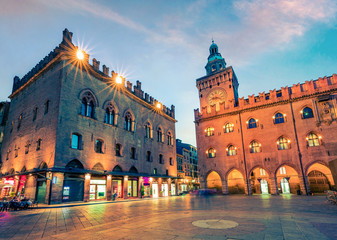 Fototapeta na wymiar Beautiful spring sunset on main square of City of Bologna with Palazzo d'Accursio and facade of Basilica di San Petronio. Great cityscape of Bologna, Italy, Europe. Traveling concept background.
