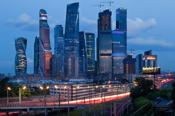Fototapeta na wymiar Moscow City, business district of skyscrapers at dusk, evening lights, roads around it, Moscow, Russia