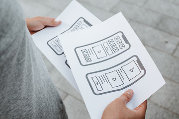 Naklejka premium UX mobile application wireframe. Sketch, prototype, framework, layout future app design project. UI/UX - user interface and user experience designer. Creative concept for smartphone. App development