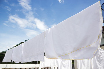 White diaper clothes laundry. Hanging on row in sunny day.