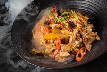 meat with vegetables on the black plate