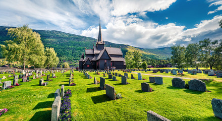 Attractive summer view of Lom stave church (Lom Stavkyrkje). Sunny morning scene of Norwegian...