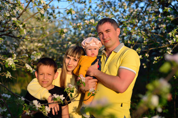 Family of four in a blossoming garden