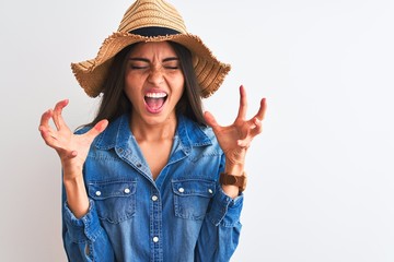 Young beautiful woman wearing denim shirt and hat standing over isolated white background...