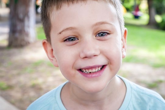 Funny adorable Caucasian 7 year old elementary school age child mildly smiling to the camera.