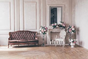 Vintage interior sofa with a vase of flowers in shabby chic style.