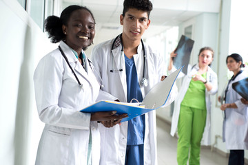 Closeup portrait of intellectual healthcare professionals with white labcoat, looking at full body...
