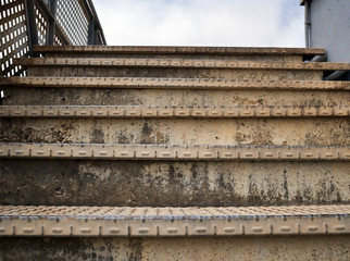 Old rusty metal staircase leading up, closeup