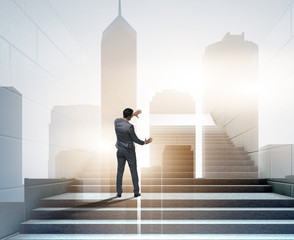Businessman climbing up challenging career ladder in business co