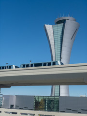 Obraz premium Air traffic control tower next to monorail