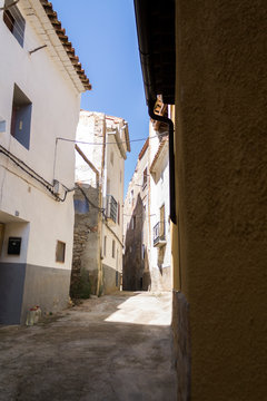 A narrow street of a village in Spain named Oliete.