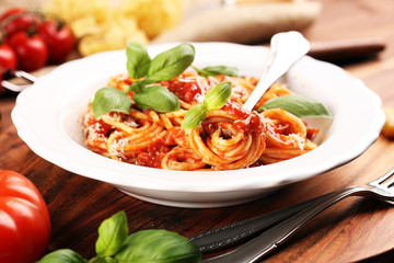 Plate of delicious spaghetti Bolognaise or Bolognese with savory minced beef and tomato sauce garnished with parmesan