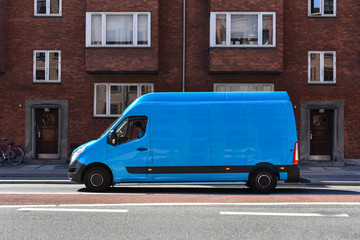 blue commercial truck delivers goods to home