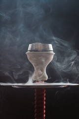  on a black background in smoke is a bowl with colaud and coals