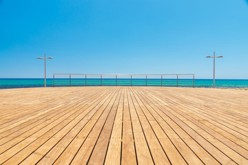 Light wooden platform on the sea coast on a summer day at the Cyprus coast.