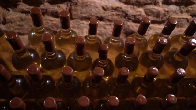 delicious expensive white wine from rare varieties of ripe grapes. glass wine bottles stacked in rows
