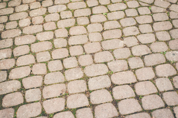 Cobbled pavement made of oval cobblestones. Backgrounds and textures