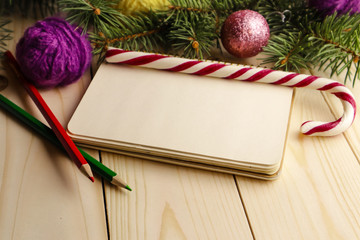 Composition with Christmas tree, notebook and buttons as decorations on wooden background