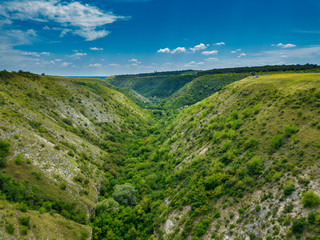 Fototapeta na wymiar Aerial view of a green rural area under blue sky. Moldova