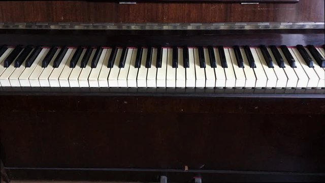 camera zoom in and out on the keys of an old piano