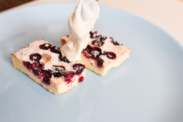 cottage cheese pie with berries. eating with a spoon. view from above.