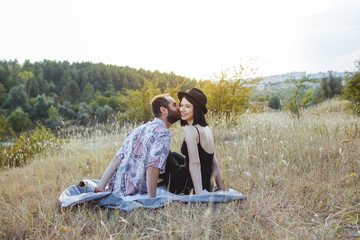 Couple feel happy on a field at sunset.