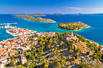 Dalmatian town of Tribunj church on hill and amazing turquoise archipelago aerial view