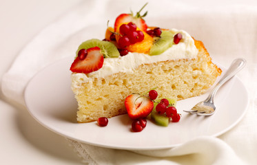 Fruit Flan with Cream with cut fruit on white plate
