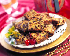 Fruit Cake Squares on Plate with Christmas like background