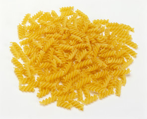 uncooked Fusilli Pasta Pile against white