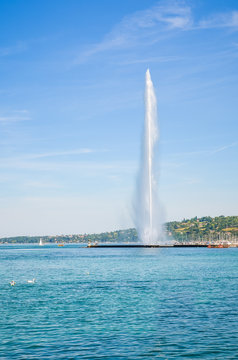 Jet d'Eau, a famous water fountain in Geneva, Switzerland located in Geneva Lake. Symbol of the beautiful Swiss city. Famous landmark and tourist attraction photographed on a sunny summer day