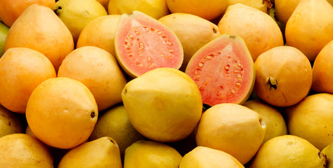 Pile of whole and half Guavas
