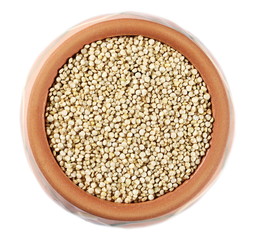 Organic quinoa seeds in clay pot isolated on white background, top view