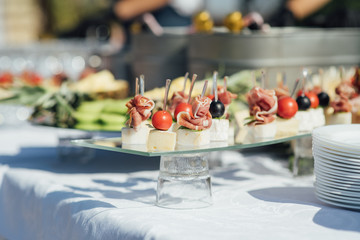 Delicious snacks on wedding reception table in luxury outdoor restaurant