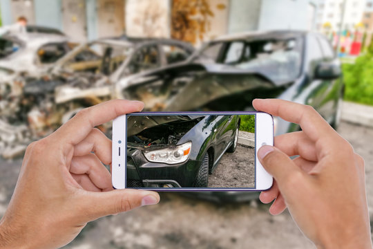 Car crash accident damaged with hand using smartphone taking photo