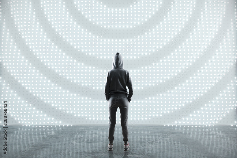 Poster Security concept with hacker back staying on concrete floor opposite abstract digital wall.